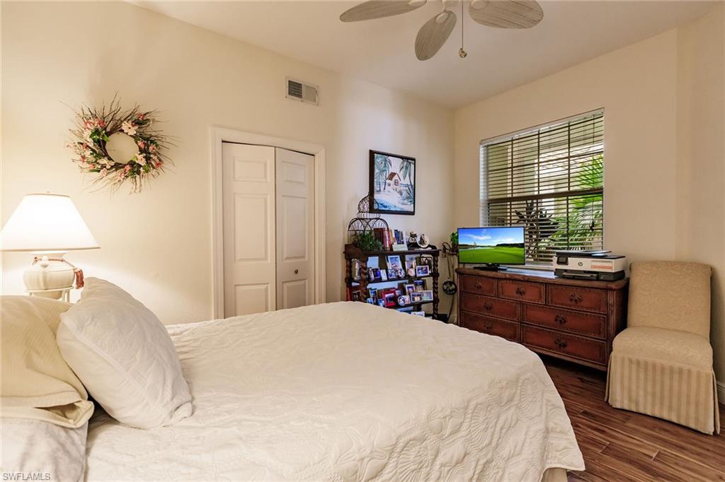 3910 Deer Crossing Court, Unit 1 Naples, FL 34114 - Photo 26 of 38 a bedroom with a bed dresser and a window