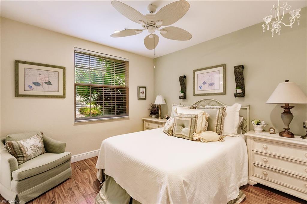 3910 Deer Crossing Court, Unit 1 Naples, FL 34114 - Photo 28 of 38 a bedroom with a large bed and a window