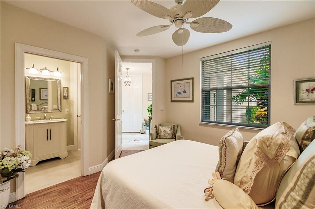 3910 Deer Crossing Court, Unit 1 Naples, FL 34114 - Photo 29 of 38 a bedroom with a large bed and a window