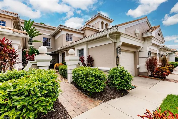 front view of a house with potted plants