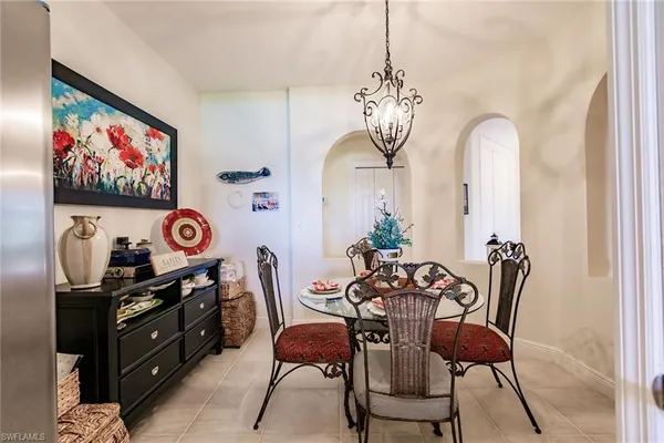 a view of a dining room with furniture and chandelier