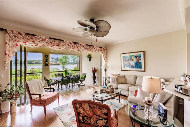 a living room with lots of furniture and a large window