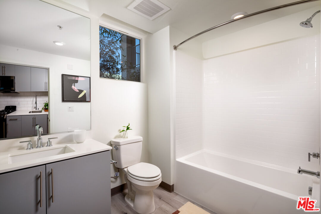750 South Oxford Avenue, Unit 430 Los Angeles, CA 90005 - Photo 27 of 28 a bathroom with a sink a toilet and shower