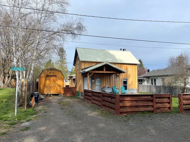 a front view of house with yard and outdoor seating