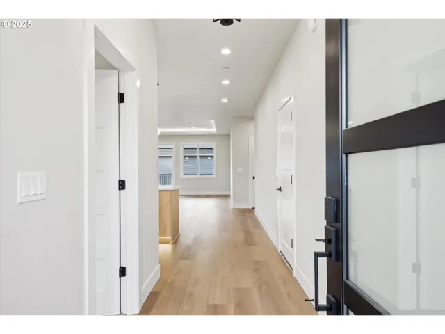 a view of hallway with wooden floor