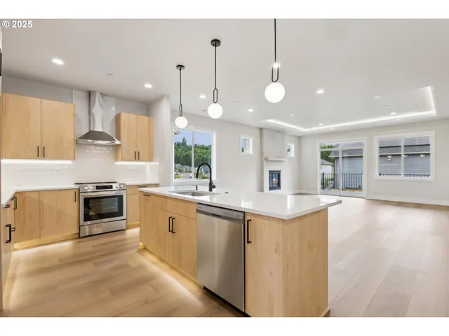 a kitchen with stainless steel appliances kitchen island a large counter top and a sink