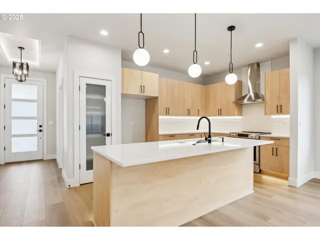 a kitchen with kitchen island a sink and wooden floor