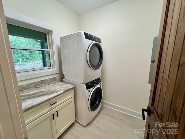 a utility room with sink dryer and washer