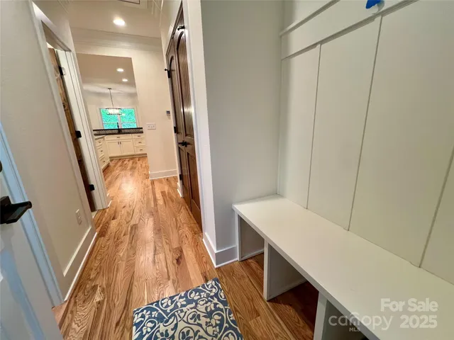 a hallway with table and wooden floor
