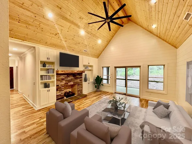 a living room with furniture a flat screen tv and a fireplace