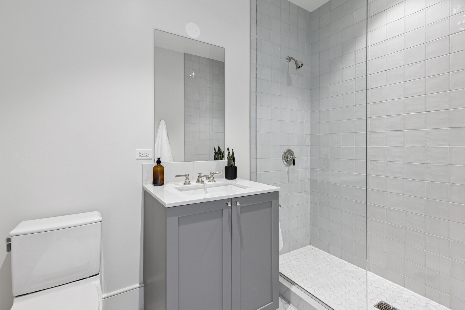 21 North May Street, Unit 703 Chicago, IL 60607 - Photo 49 of 56 a bathroom with a sink a toilet and a mirror