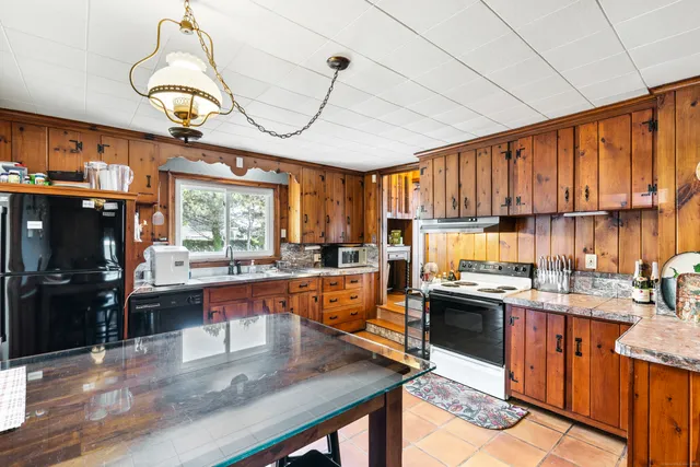 a kitchen with lots of counter top space appliances and a window