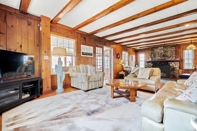 a bedroom with furniture and a flat screen tv