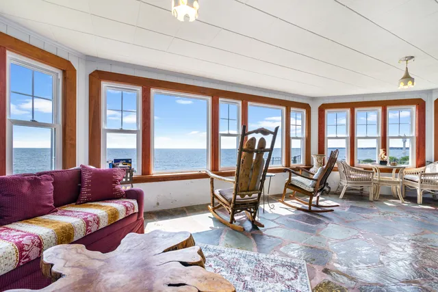 a living room with furniture gym equipment and a large window