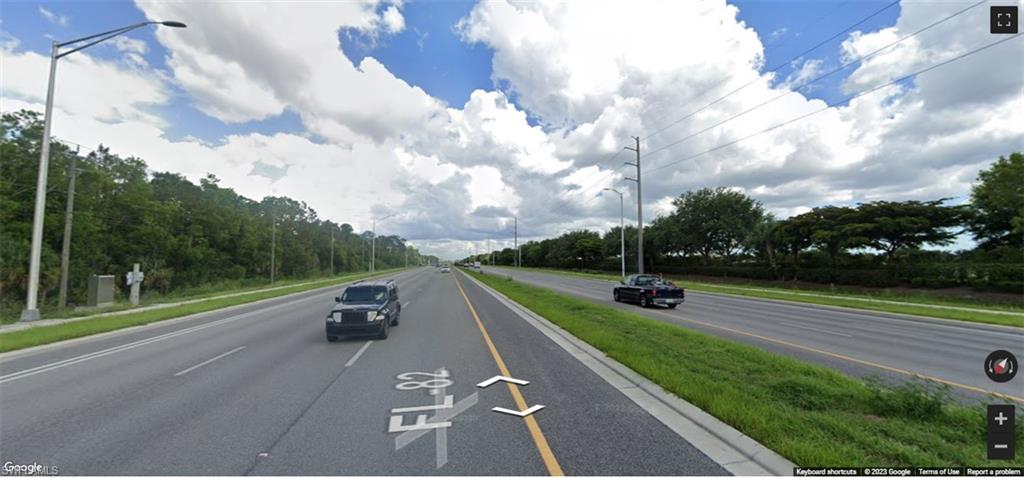 View of asphalt street with street lighting and sidewalks