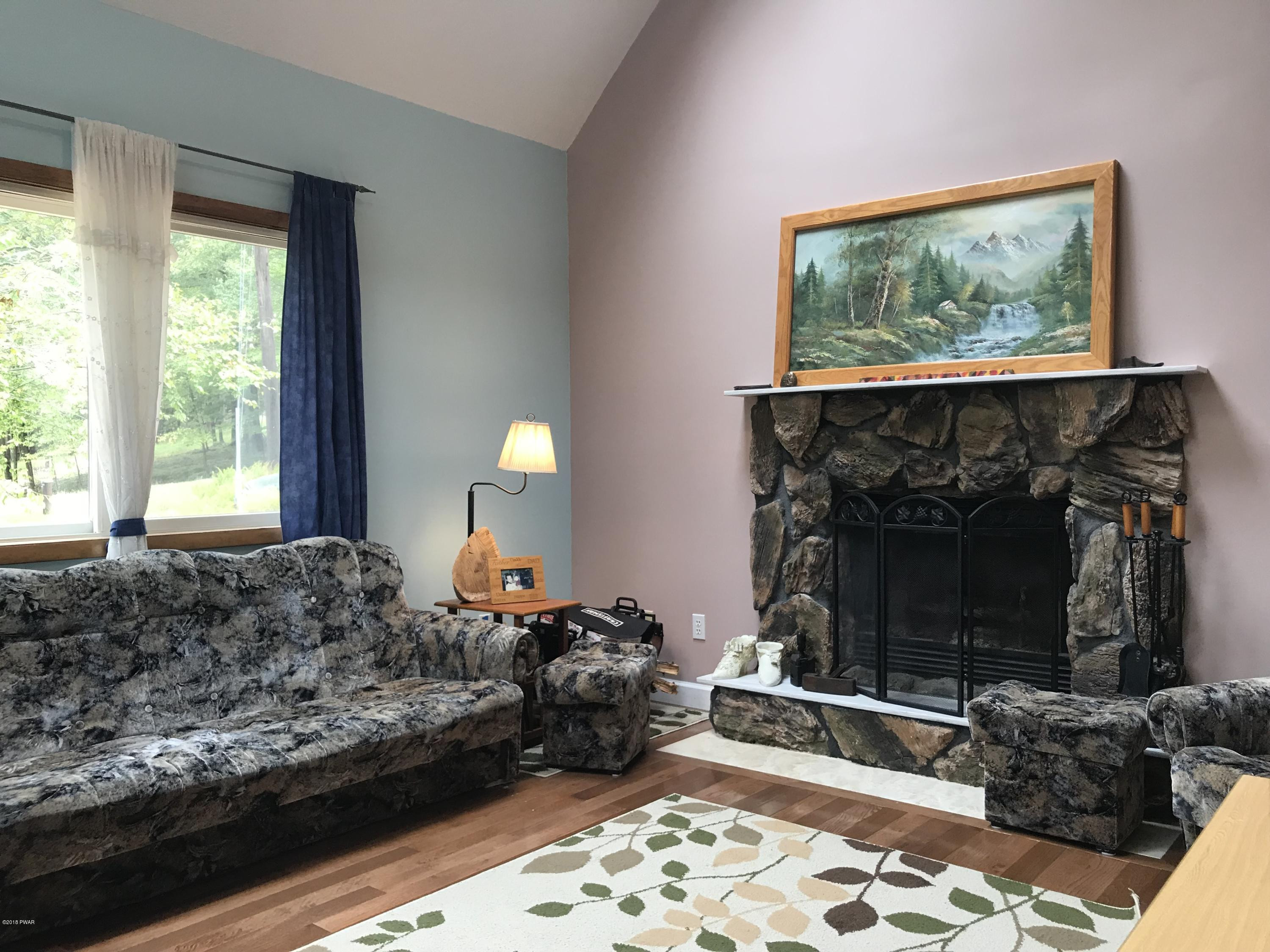 123 Stonehenge Road Milford, PA 18337 - Photo 2 of 25 a living room with furniture and a fireplace