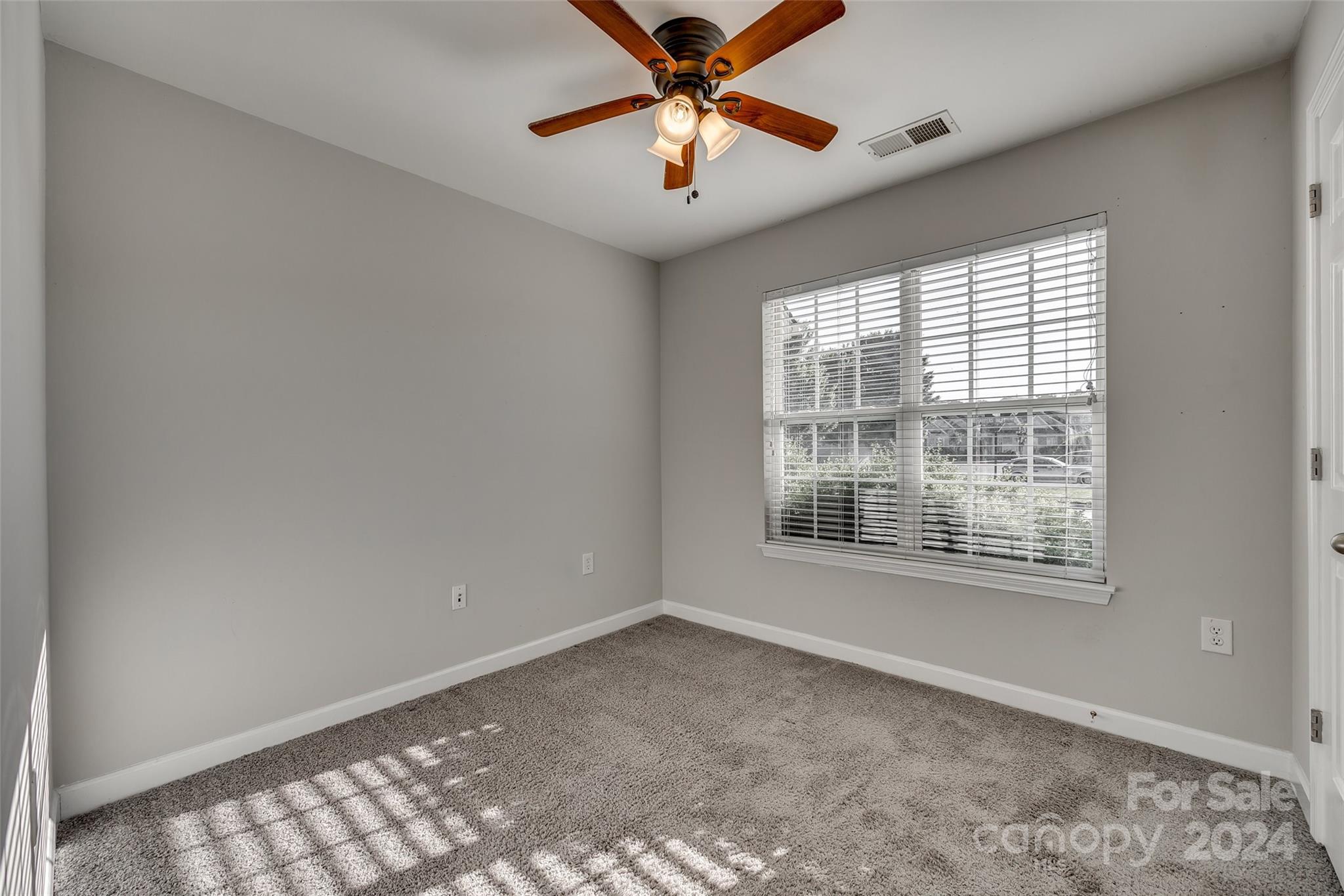 1446 Harpers Inlet Drive Clover, SC 29710 - Photo 14 of 28 a view of an empty room with window and a chandelier fan