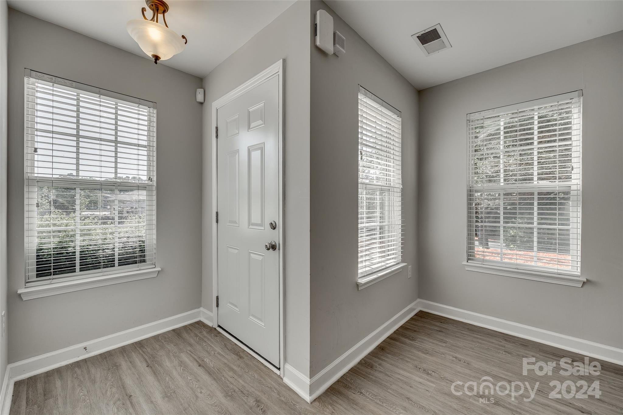 1446 Harpers Inlet Drive Clover, SC 29710 - Photo 3 of 28 a view of an empty room with a window and wooden floor