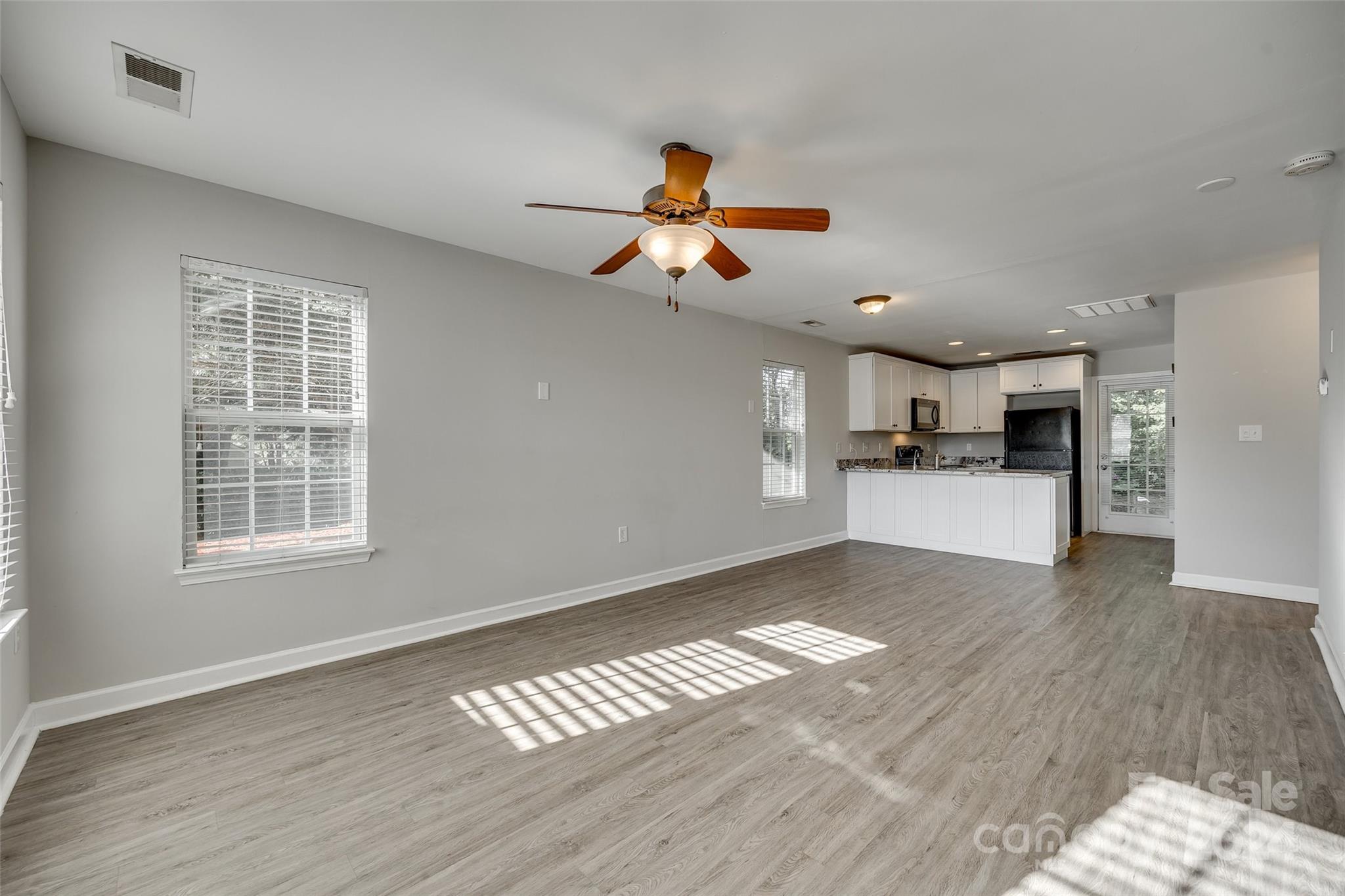1446 Harpers Inlet Drive Clover, SC 29710 - Photo 4 of 28 a view of a kitchen with wooden floor and a kitchen space