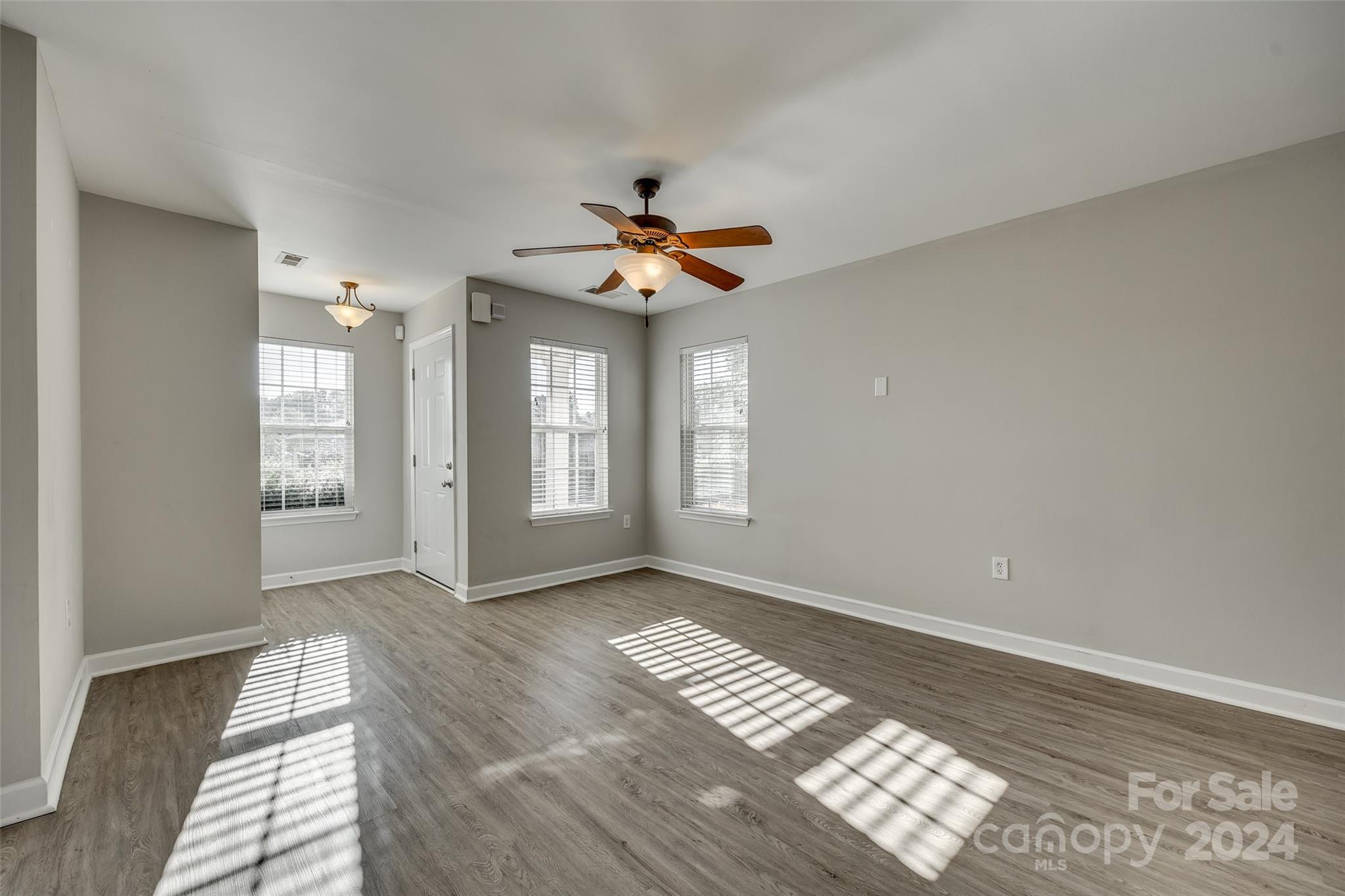 1446 Harpers Inlet Drive Clover, SC 29710 - Photo 5 of 28 a view of an empty room with window and wooden floor