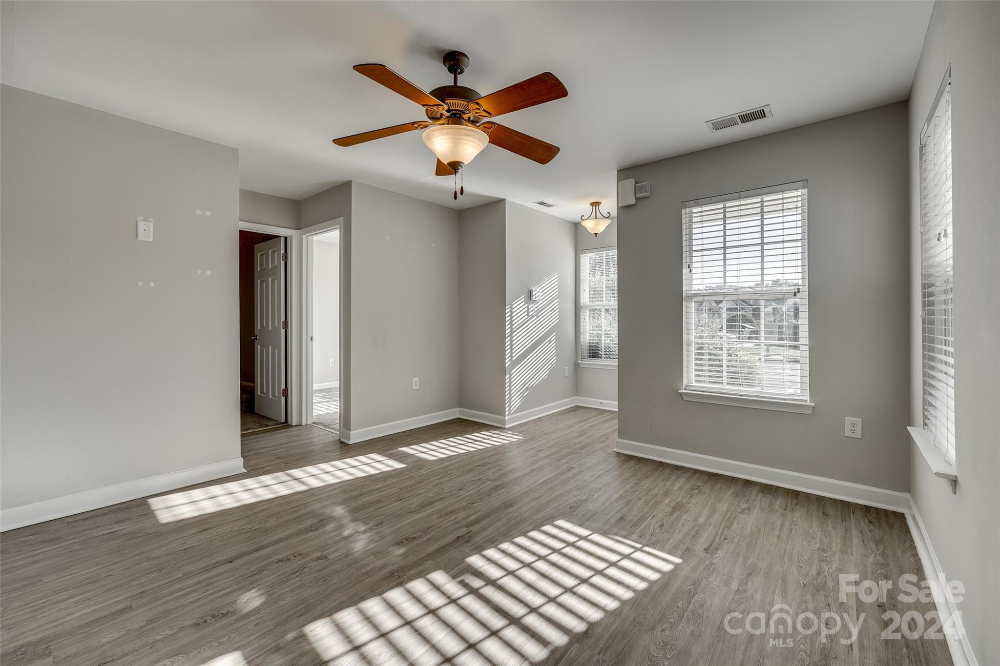 1446 Harpers Inlet Drive Clover, SC 29710 - Photo 6 of 28 a view of an empty room with wooden floor and a window