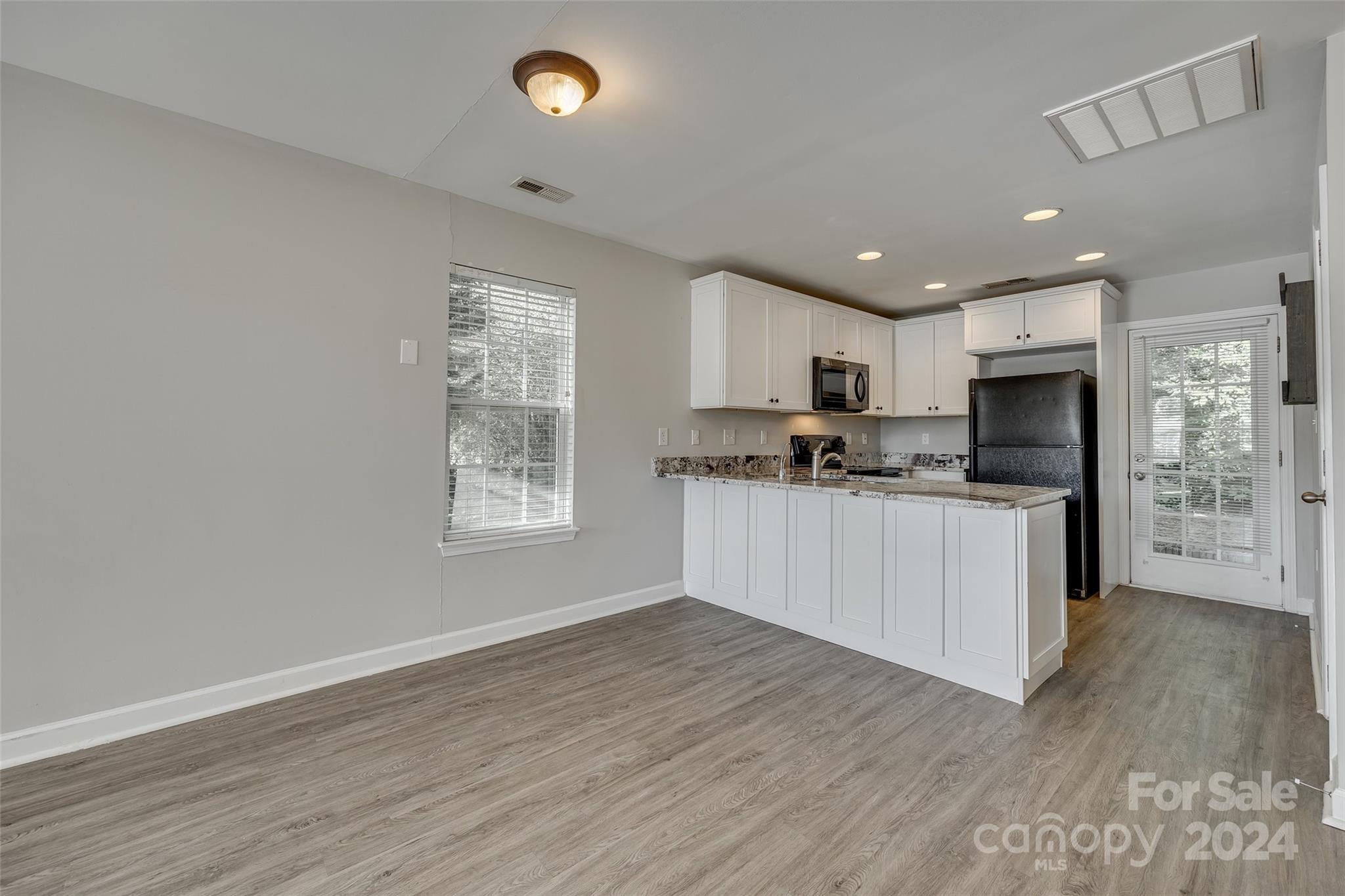 1446 Harpers Inlet Drive Clover, SC 29710 - Photo 7 of 28 a kitchen with stainless steel appliances granite countertop a stove a sink and a refrigerator