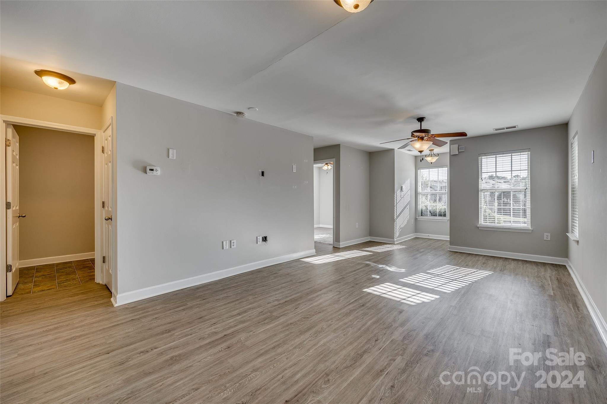 1446 Harpers Inlet Drive Clover, SC 29710 - Photo 8 of 28 an empty room with wooden floor and windows