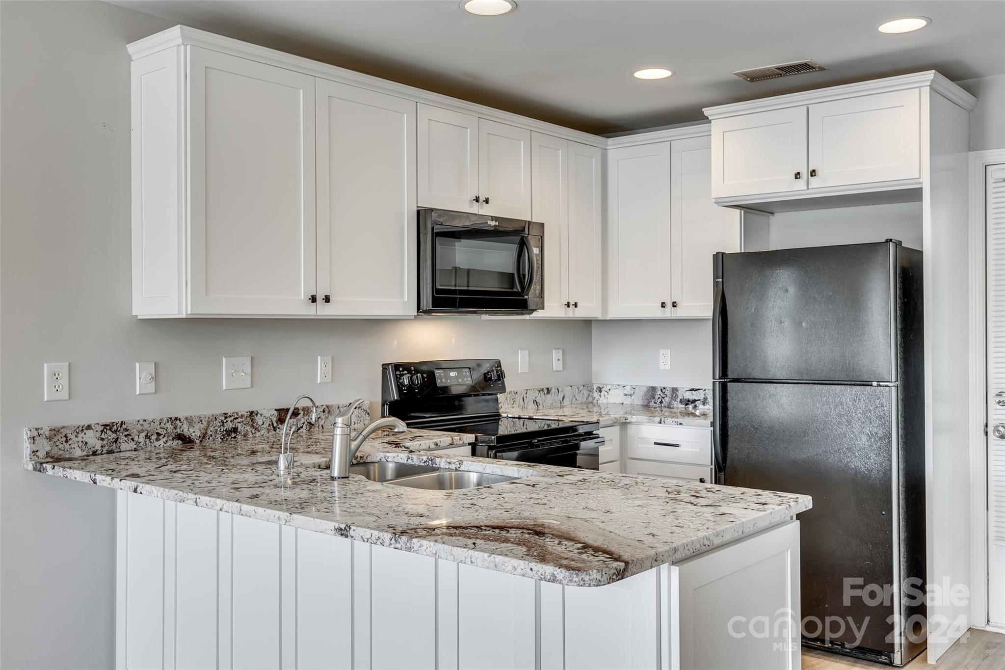 1446 Harpers Inlet Drive Clover, SC 29710 - Photo 9 of 28 a kitchen with stainless steel appliances granite countertop a refrigerator sink microwave and stove