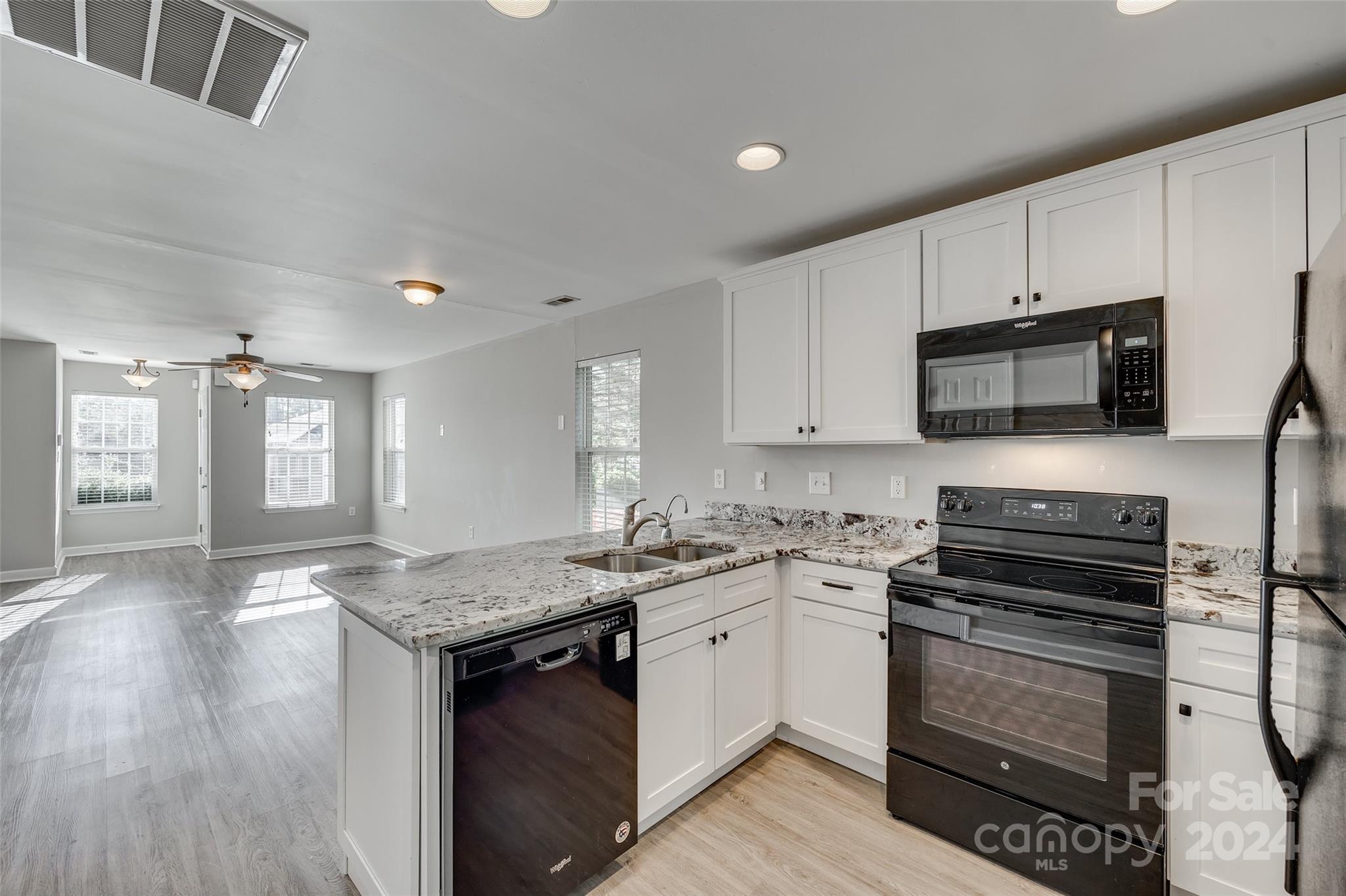 1446 Harpers Inlet Drive Clover, SC 29710 - Photo 10 of 28 a kitchen with a stove a sink and a microwave