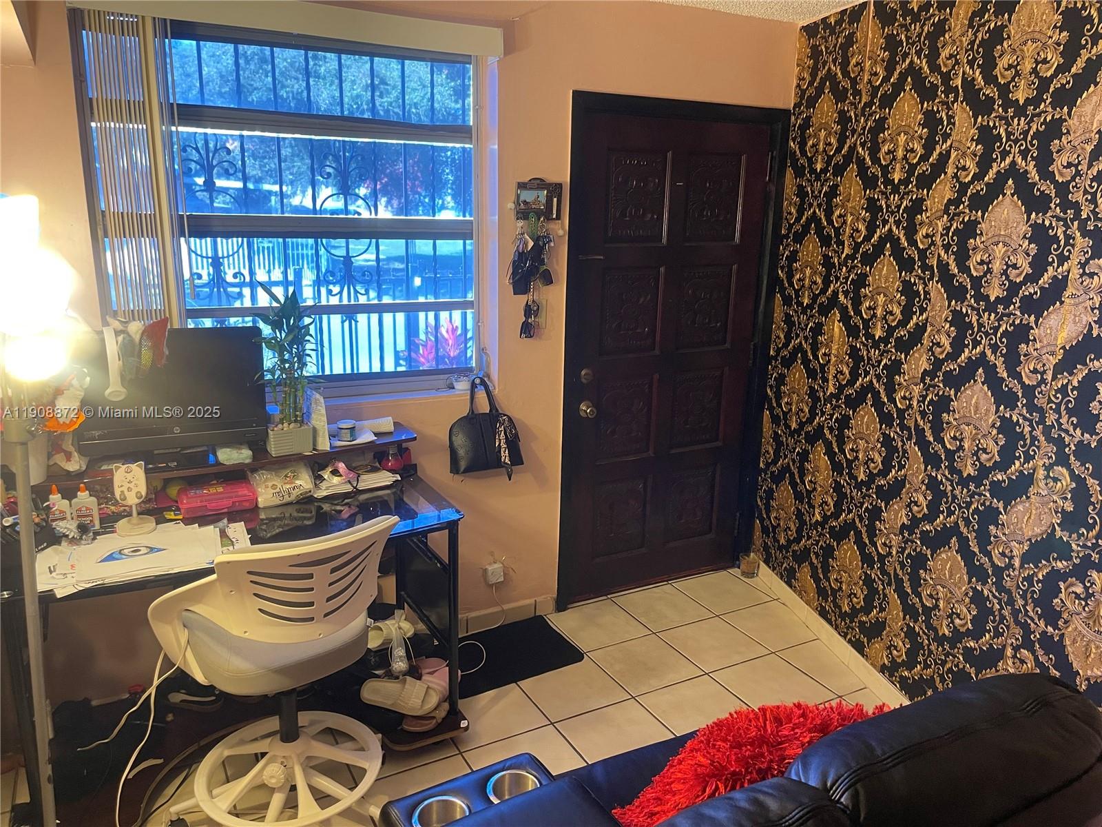 1832 Southwest 3rd Street Miami, FL 33135 - Photo 13 of 25 a room with furniture a rug and a window