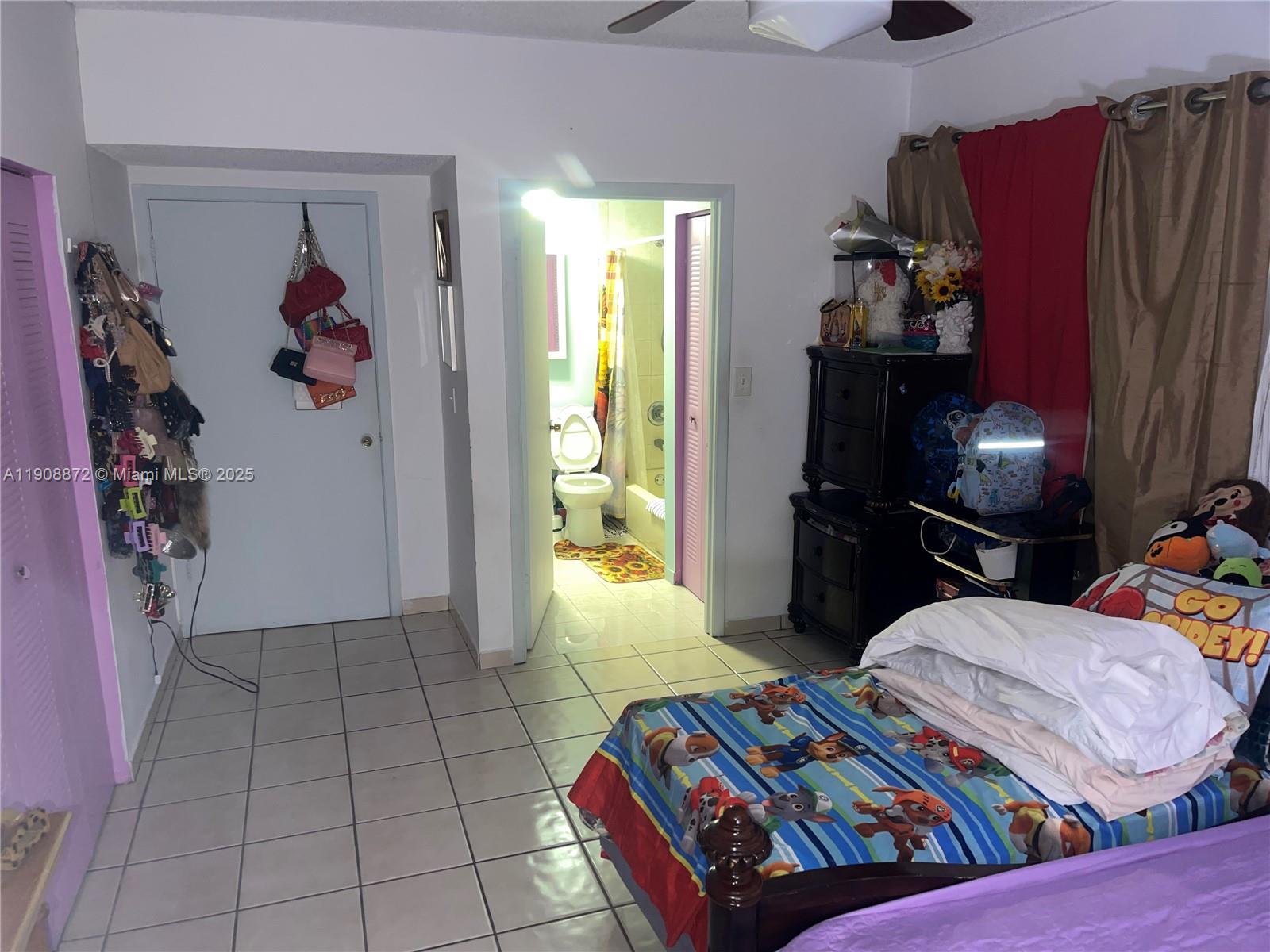 1832 Southwest 3rd Street Miami, FL 33135 - Photo 21 of 25 a bedroom with a bed and a television