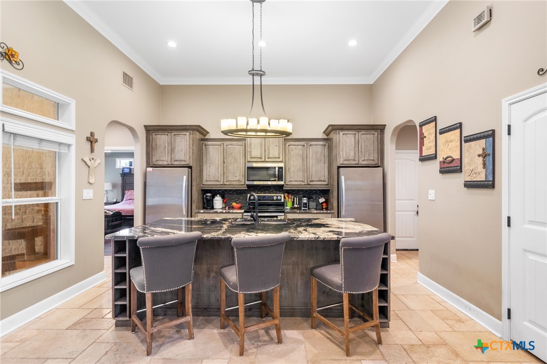 7134 Old Hwy Road Inez, TX 77968 - Photo 14 of 40 a kitchen with refrigerator and chairs