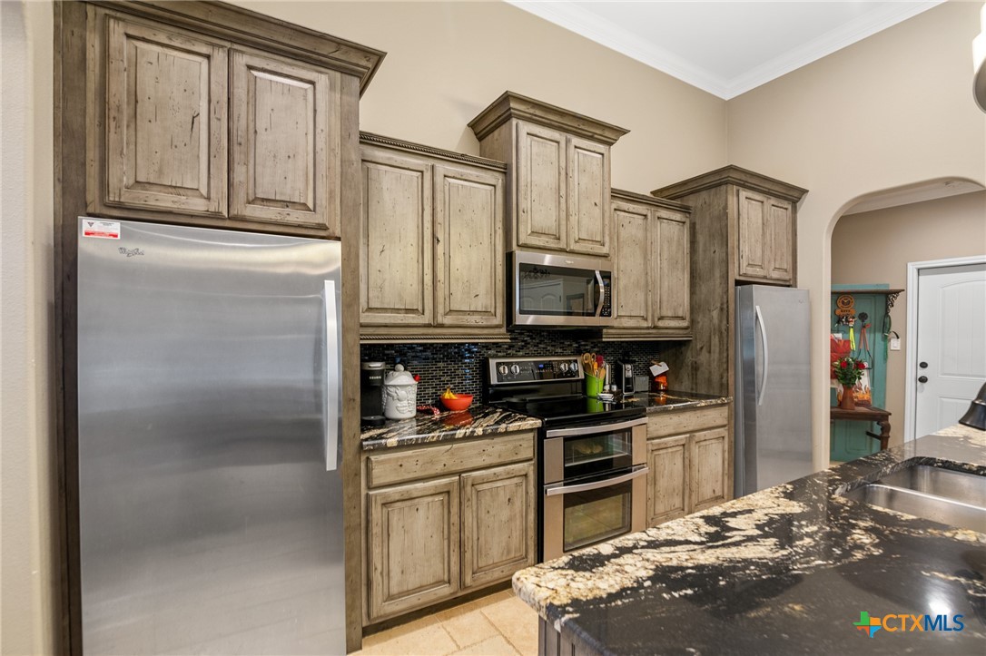 7134 Old Hwy Road Inez, TX 77968 - Photo 15 of 40 a kitchen with stainless steel appliances granite countertop a refrigerator a stove and a sink with dishwasher