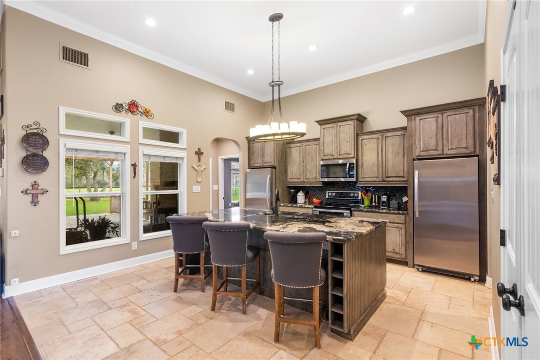 7134 Old Hwy Road Inez, TX 77968 - Photo 16 of 40 a kitchen with kitchen island granite countertop appliances cabinets and furniture