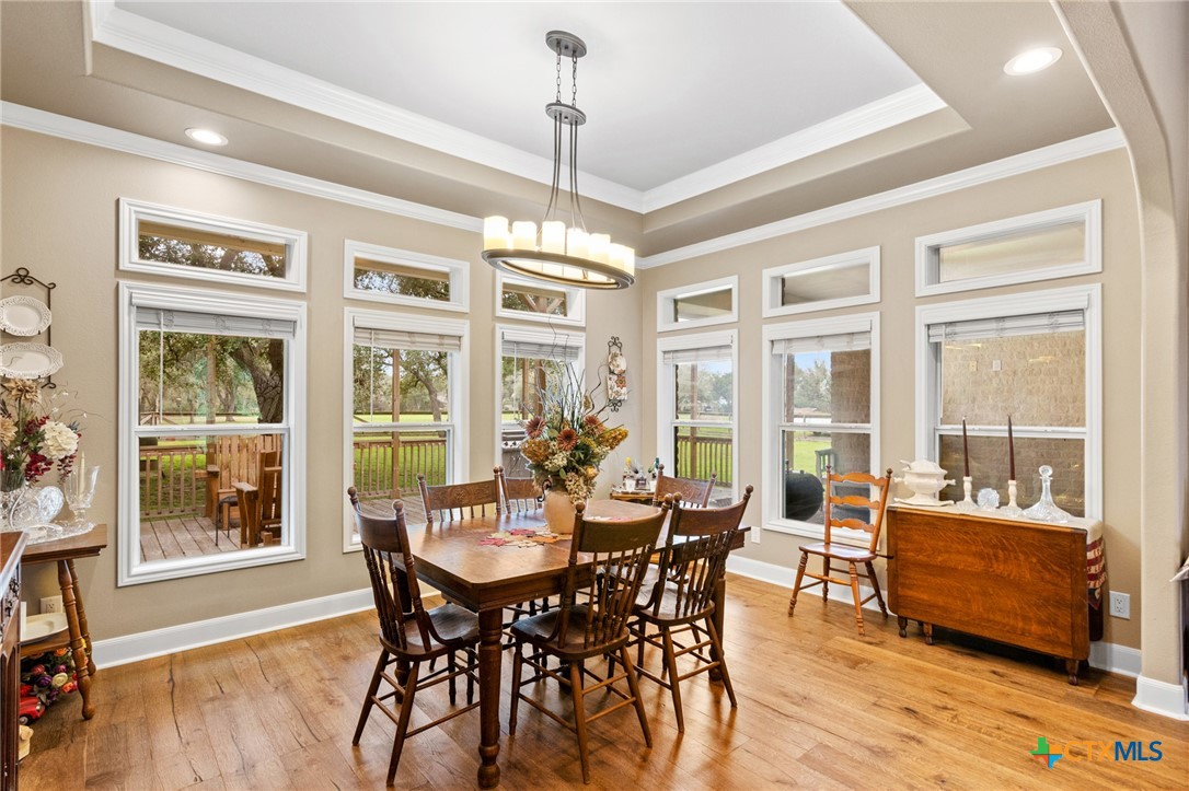 7134 Old Hwy Road Inez, TX 77968 - Photo 19 of 40 a view of a dining room with furniture large windows and wooden floor