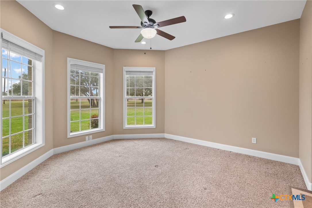 7134 Old Hwy Road Inez, TX 77968 - Photo 20 of 40 an empty room with windows and ceiling fan