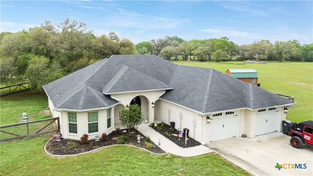 an aerial view of a house with swimming pool garden and patio