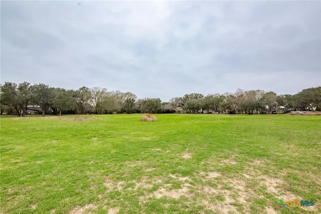 a view of a lake with houses in the background