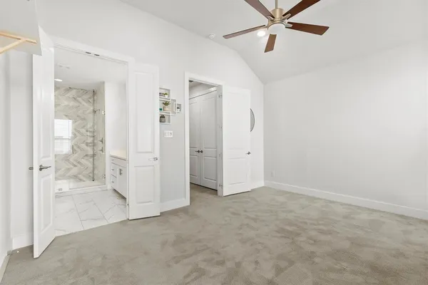 an empty room with fan and entrance