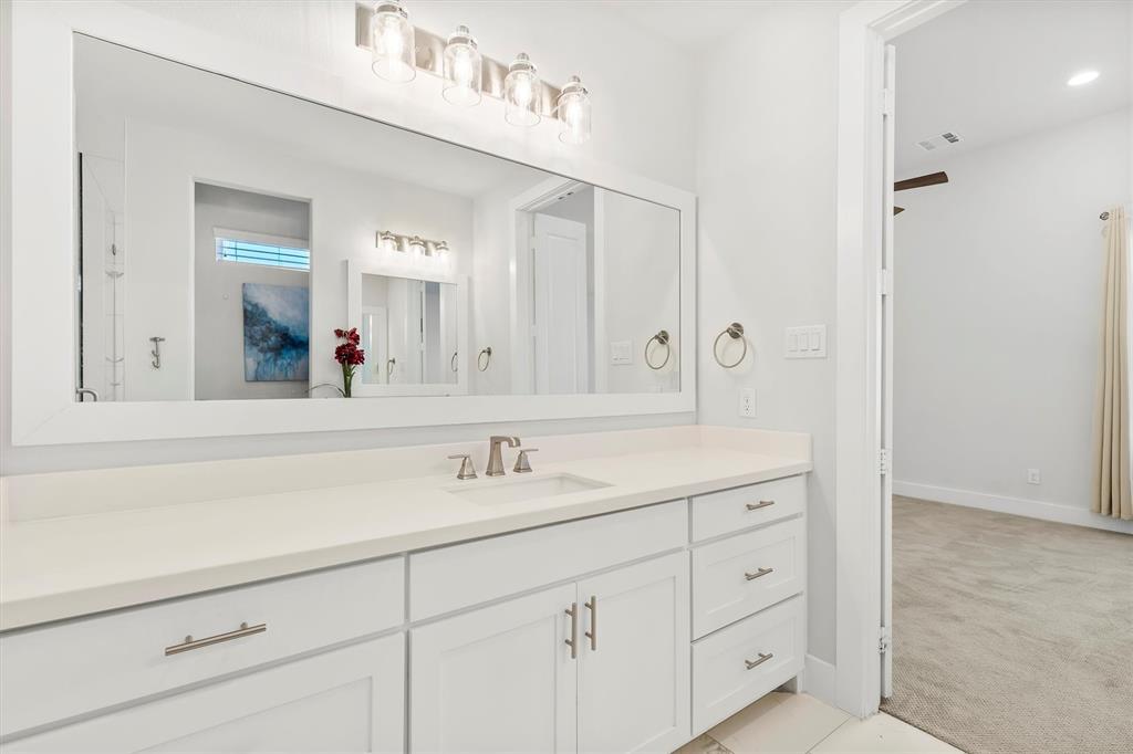 1103 Lavender Ridge Dallas, TX 75204 - Photo 15 of 30 a bathroom with a sink vanity and mirror