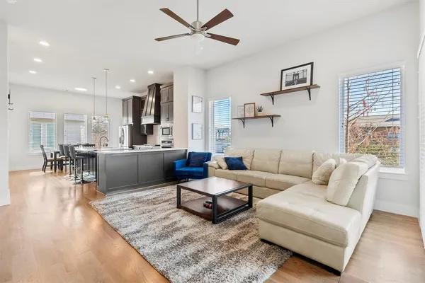 a living room with furniture and kitchen view
