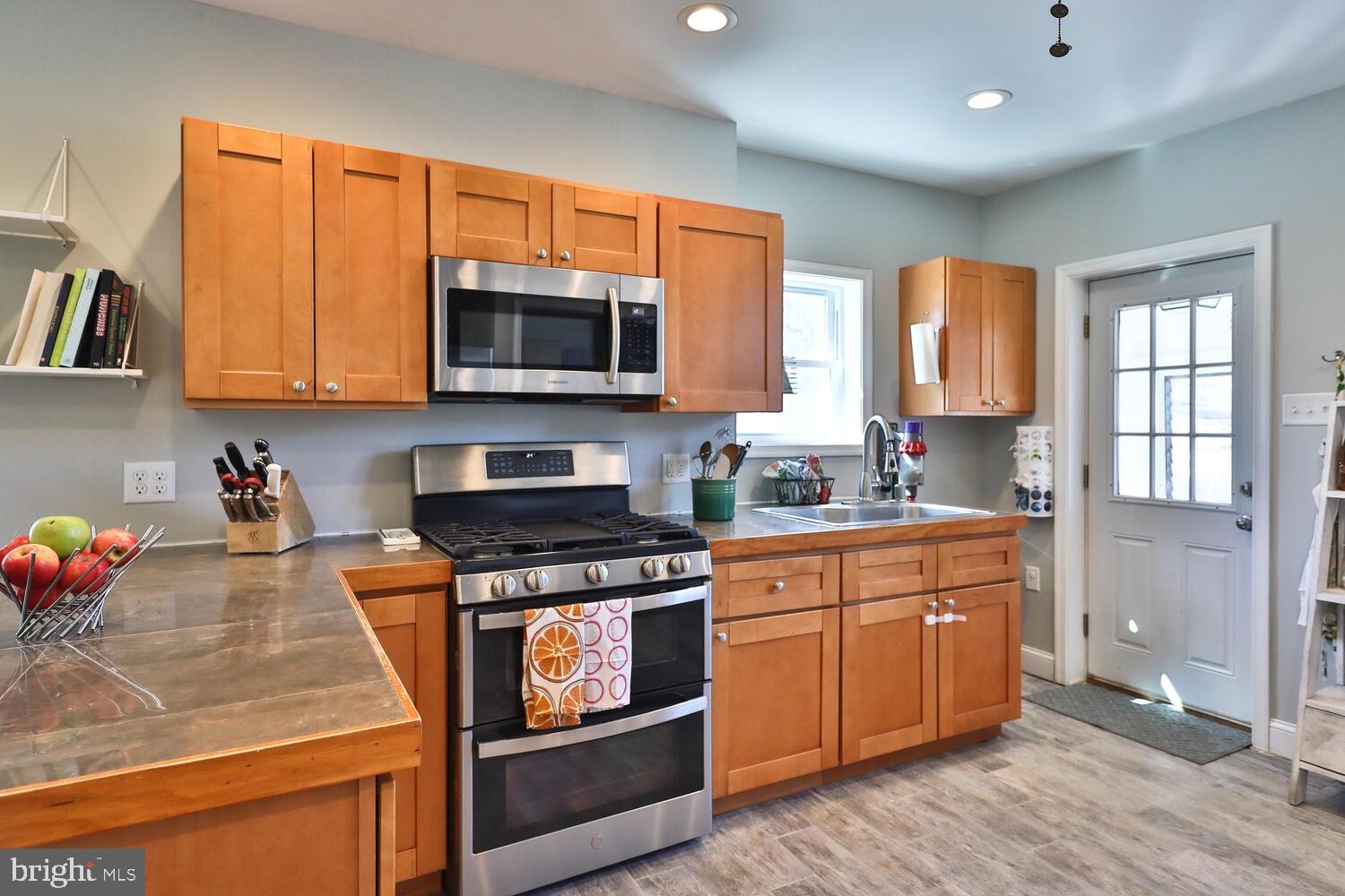 388 Ripka Street Philadelphia, PA 19128 - Photo 15 of 38 a kitchen with stainless steel appliances granite countertop a stove a sink and a microwave