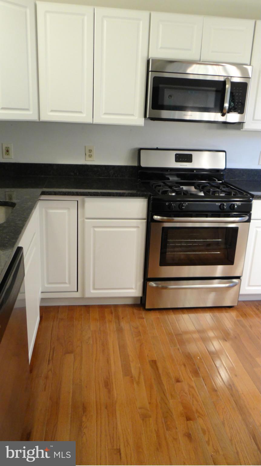 308 Rover Court Stafford, VA 22554 - Photo 3 of 14 a kitchen with granite countertop a stove and a microwave
