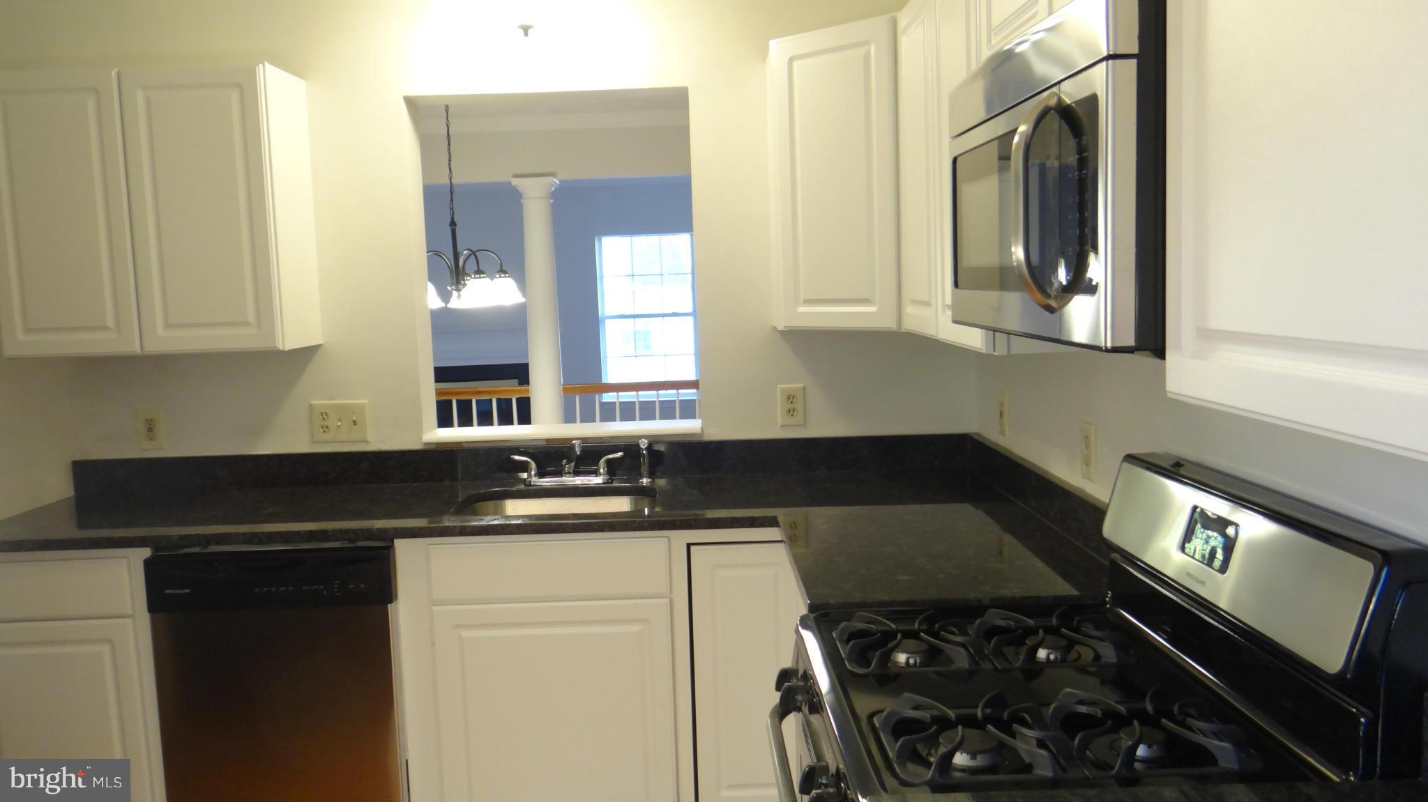 308 Rover Court Stafford, VA 22554 - Photo 5 of 14 a kitchen with a sink a stove cabinets and a window