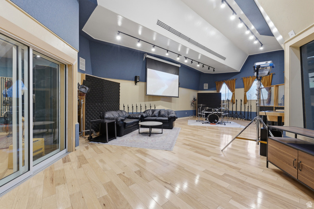 702 Alpine Highway Alpine, UT 84004 - Photo 61 of 83 Spacious room featuring light wood-finish flooring, a vaulted ceiling with track lighting, and a projection screen