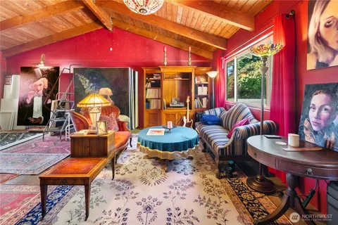 a living room with furniture a rug and a fireplace