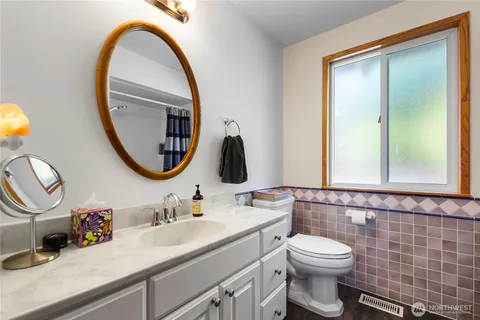 a bathroom with a toilet a sink and a mirror