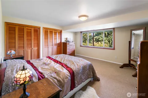 a bed sitting in a bedroom next to a window