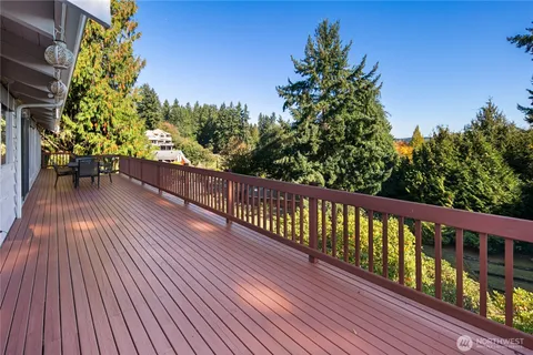 a view of balcony with wooden floor and outdoor seating