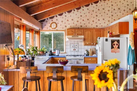 a living room filled with furniture windows and a chandelier